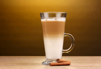 Fragrant сoffee latte in glass cup and cinnamon