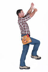 Naklejka premium A handyman miming.