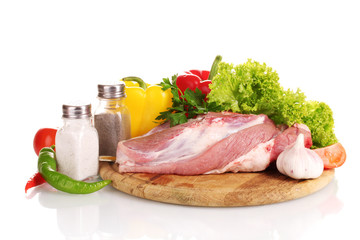 Raw meat and vegetables on a wooden board isolated on whitе