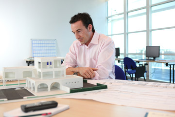 Architect with a model of a building