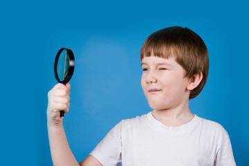 Boy with magnifying glass