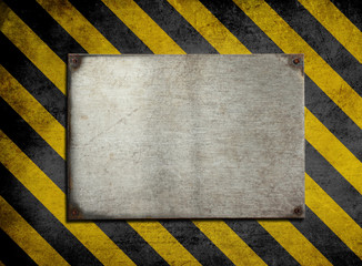old metal plate background with hazard stripes
