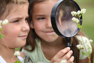Children with a magnifying glass
