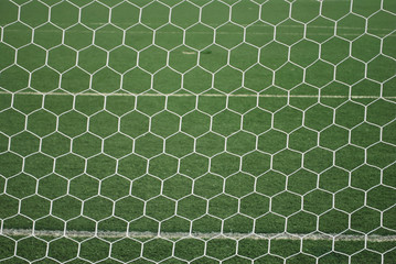 Fototapeta premium Behind goal net at football field