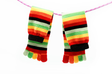 Colorful fun sock hanging on a rope.