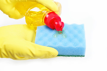 Hands in rubber gloves with a bottle of detergent and sponge on