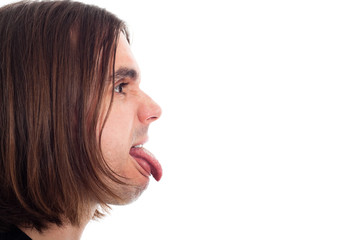 Profile of man face sticking out tongue