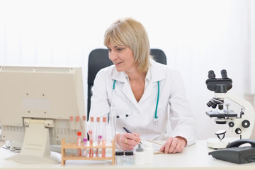 Middle age doctor woman working at office