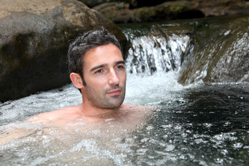 Closeup of man bathing in natural river water