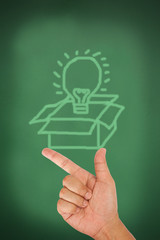 Hand pointing on think out of the box on blackboard