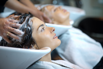 Beautiful woman getting a hair wash. In a hair salon