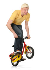 Obraz premium The curious man on the children's bicycle