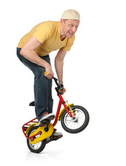 Fototapeta na wymiar The curious man on the children's bicycle
