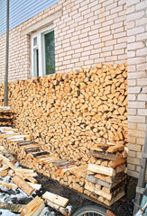 firewood near wall of the rural building