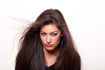 Wondering.. Young  confident woman with long hair posing