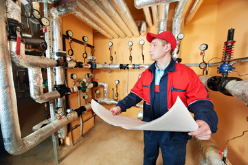 heating engineer repairman in boiler room