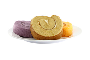 Three color sweet roll cake focus on brown dish.