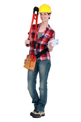 Tradeswoman holding large clippers and rolled-up drawings