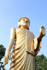 Big stand golden buddha giving mercy.