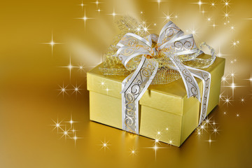 Golden gift box or present with ribbon and bow