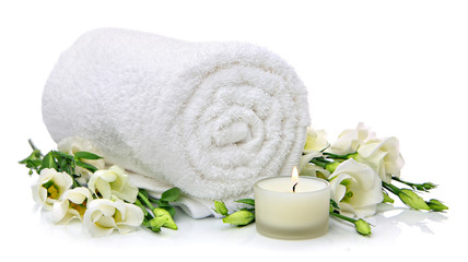 Rolled towel with flowers and candlelight
