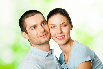 Portrait of young smiling couple, outdoors