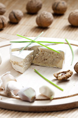 cheese brie filled with cheese mixture of chopped walnuts and ga