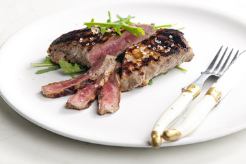 grilled beefsteak pickled in Dijon mustard with ruccola