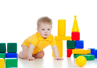 Fototapeta na wymiar baby boy playing with building blocks