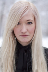 Portrait of the serious girl on a winter background