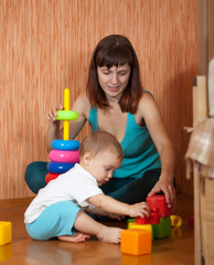 Baby girl plays with toy blocks