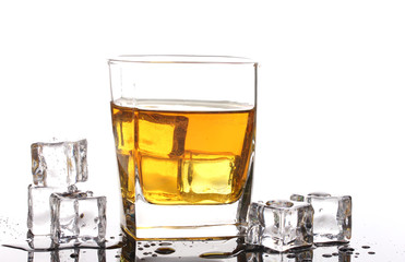 Glass of scotch whiskey and ice isolated on white