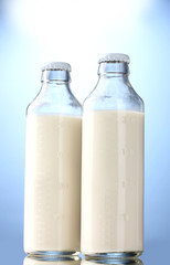 bottles of milk on blue background