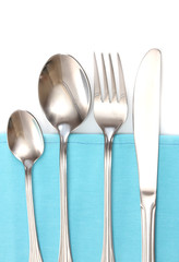 Fork, spoon and knife on a blue tablecloth