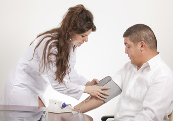 Fototapeta premium Doctor measuring blood pressure - studio shot