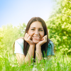 beauty young woman relaxing on grass