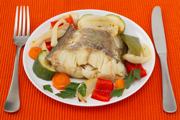 boiled fish with vegetables on the plate