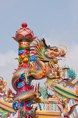 dragon Chinese statue on top of general temple roof  against blu