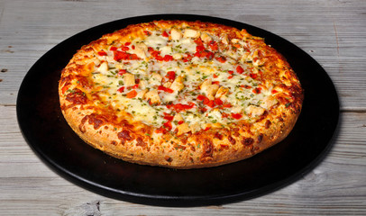 Pizza Chicken parmesan with tomato onion on old vintage wood tab