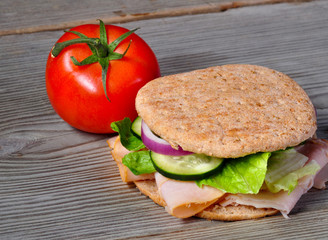 Turkey sandwich on whole wheat with onion, cucumber, lettuce and