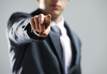 businessman  hand pointing out at you