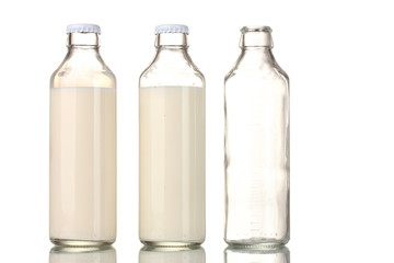 Bottle of milk and an empty bottle isolated on white