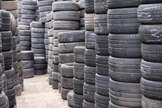 Stacks of car tyres on concrete