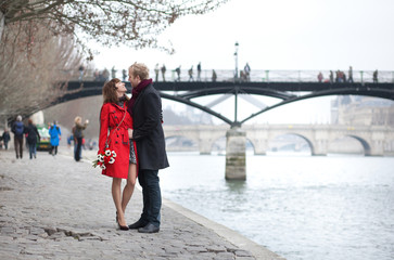 Romantic couple in love dating near Pont des Arts in Paris