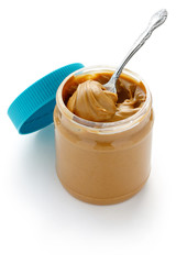 an open jar of peanut butter with spoon