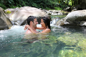 Couple having a bath in fresh river water