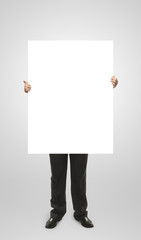 Businessman holding a blank white board