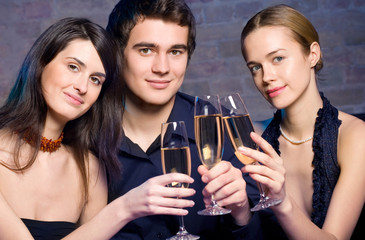 Young happy people with champagne at party