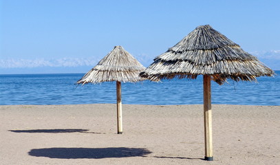 Two beach umbrellas on the sand