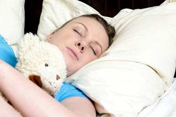 Obraz na płótnie Canvas Young girl fell asleep with teddy bear